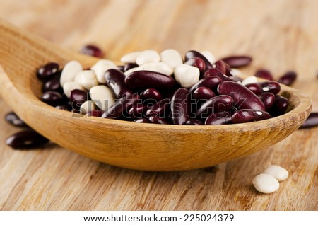 Red and white Kidney beans on  a wooden table . Selective focus