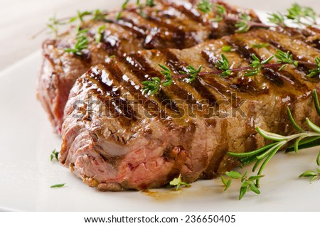 Beef steak on a  white plate . Selective focus