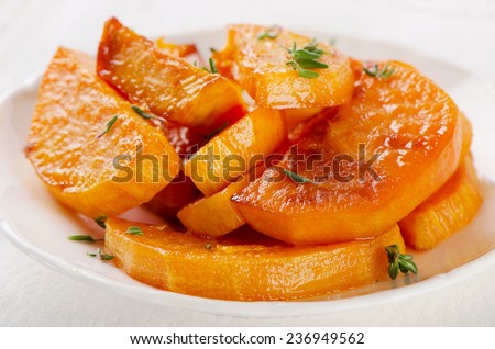 Baked sweet potato wedges on a white plate. Selective focus