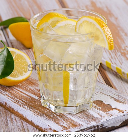 Glass of fresh water with a lemon. Selective focus