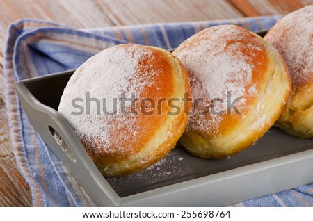 Sweet homemade donuts in wooden box. Selective focus