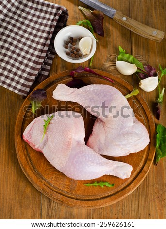 Fresh raw chicken legs on  kitchen cutting board. Top view