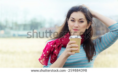 Woman with Coffee in To-Go Cup outdoors. Selective focus