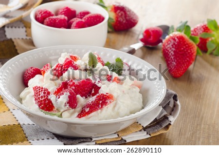 Fresh Cottage cheese with berries on  a wooden table. Selective focus