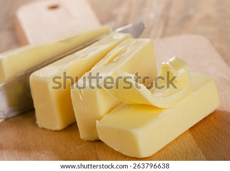 Butter on a wooden  board . Selective focus