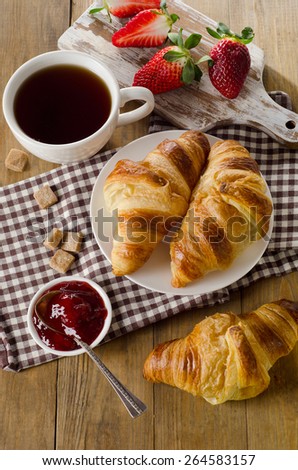 Fresh croissants with coffee cup for a breakfast. Top view