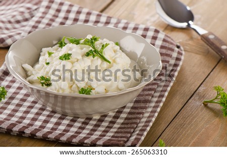 Fresh Cottage cheese with fresh herbs on  wooden table.