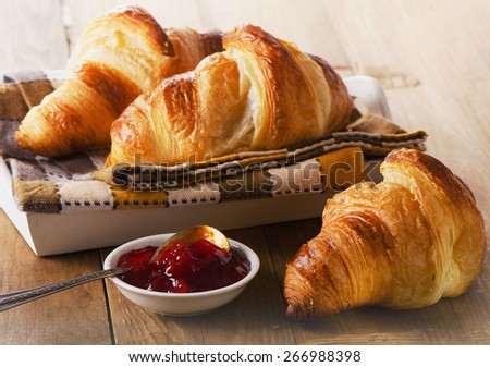Fresh Croissants on   wooden background . Selective focus