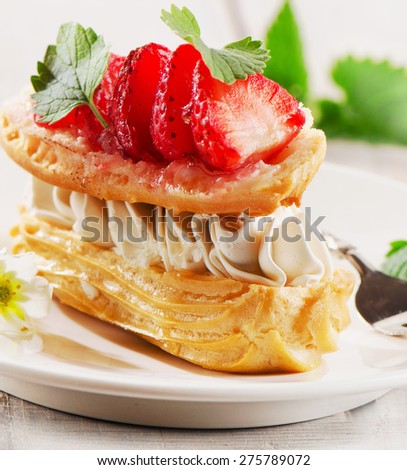 Sweet cream puff with strawberries. Selective focus