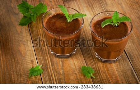 Homemade Chocolate Mousse in glasses on a old rustic    wooden table. Selective focus