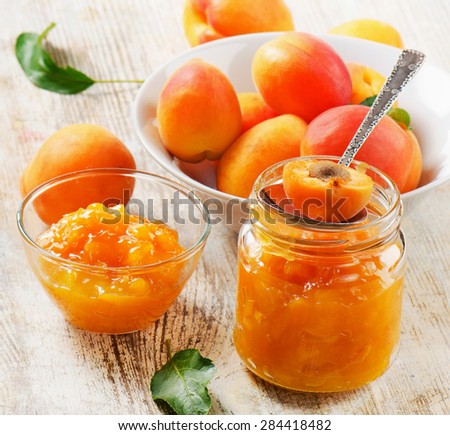 Fresh apricots jam on a wooden table. Selective focus