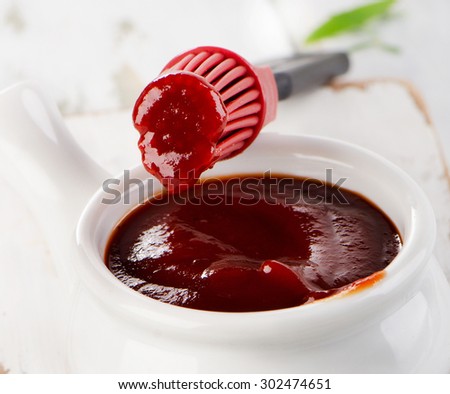 BBQ sauce in  bowl with a brush. Selective focus