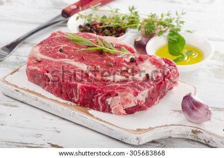 Raw ribeye steaks on the cutting board. Selective focus