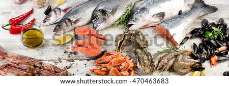 Fresh fish and other seafood on wooden background. Top view