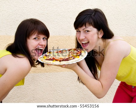 Two young woman eating