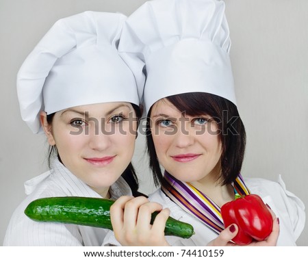 Young  cook woman with vegetables isolated on white background
