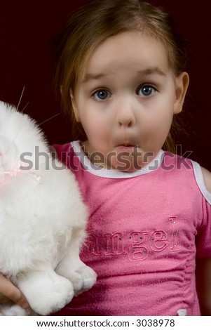 The small surprised girl with a toy