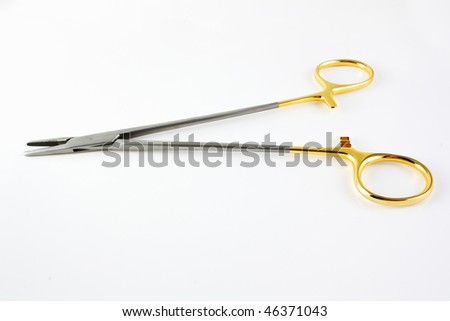 Surgical medical clamp with golden handle over white background