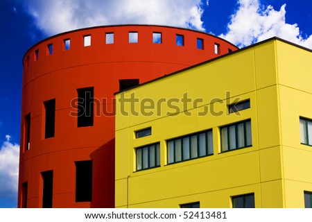 Colored buildings against the blue sky with some clouds