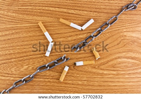 Wooden background texture with some  cigarettes and broken chain stop smoking concept landscape view
