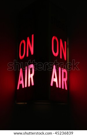 On Air studio sign illuminated.  Vertical aspect with dual lights and red glow.