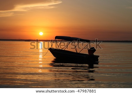 Leisure boat at sunrise waiting for the dawn of a new adventure.
