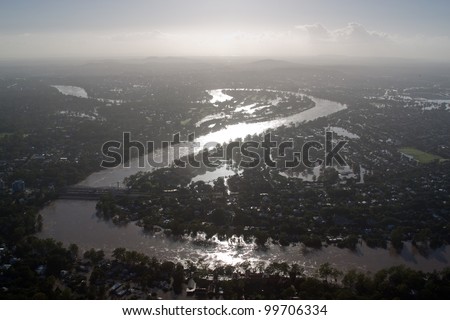 Aerial view Brisbane River Flood January 2011 Silhouette. Dramatic highlights show river meandering through the city during its darkest hour.