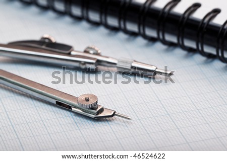 Compasses on graph paper closeup