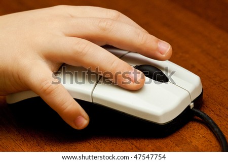 Children\'s hand on computer mouse close up