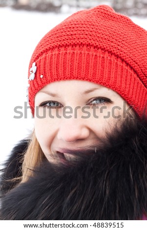 Portrait of a young woman in winter clothes close