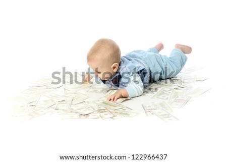 little baby lying on a pile of dollars