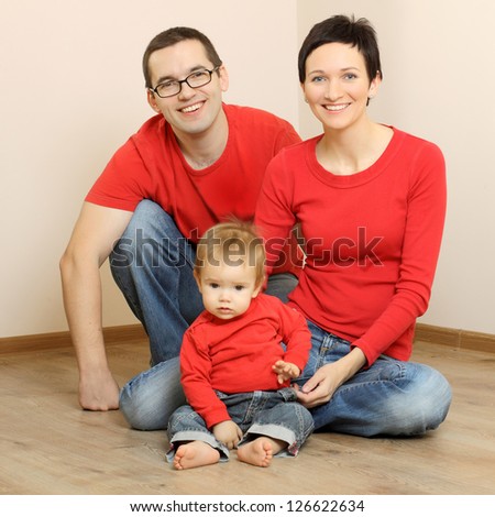 Happy family in jeans and a red shirts