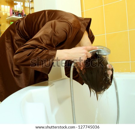 Woman in the bathroom washing her hair