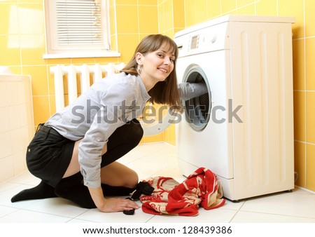 Ordinary simple beautiful girl near a washing machine