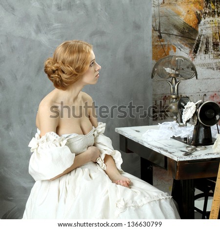 Woman in vintage dress sitting near retro sewing machine