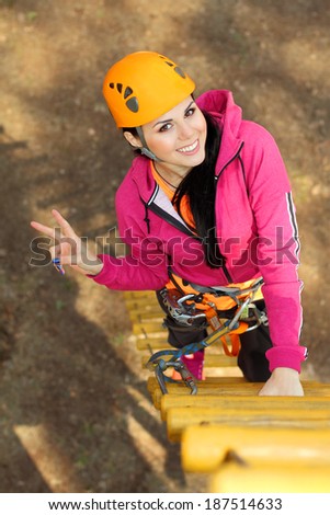 Beautiful girl climber climbs up the stairs