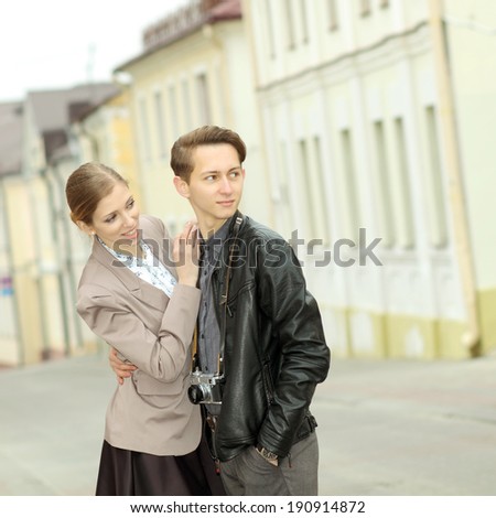 Young fashion couple posing outdoor in summer. Handsome man and pretty beautiful woman outdoor vintage portrait.