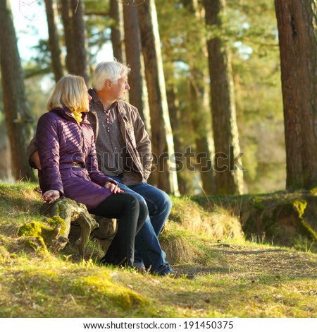 Beautiful elderly couple embracing and enjoying life in the forest at sunset. couple of grandparents embracing