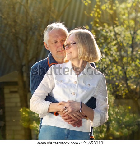Elderly couple in love. Beautiful elderly couple gently embracing at sunset. couple of grandparents embracing