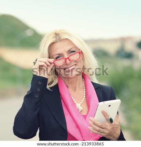 mature business woman with tablet. Smiling business woman. Outdoors.