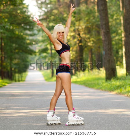 Young woman on roller skates. skinny blonde girl learn to roller skate