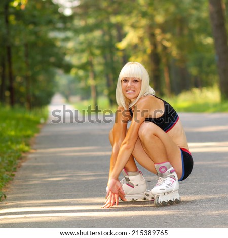 Young woman on roller skates. skinny blonde girl learn to roller skate
