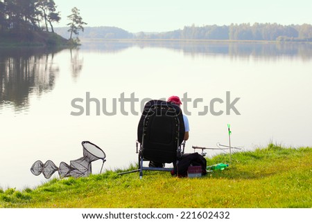 Fisherman fishing. Feeder sport. A fisherman catches a fish in the morning at sunrise in the fog