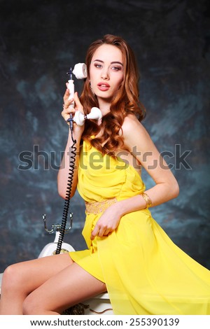 Pin-up girl talking on retro telephone. beautiful young girl with a vintage telephone survey in retro style