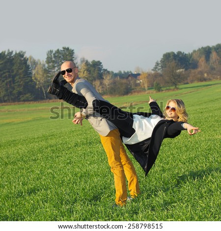 The couple has emotional and crazy fun outdoors. young beautiful couple having fun outdoors. Young happy couple outdoor portrait.
