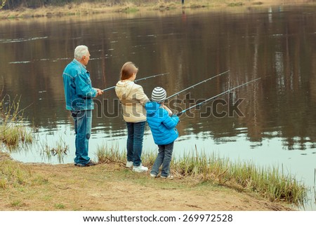 Grandfather and grandchildren are fishing