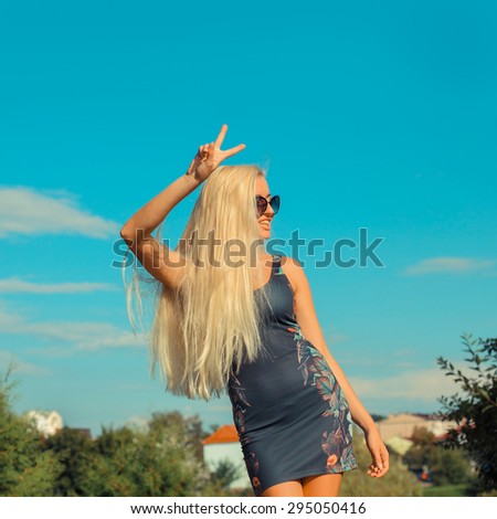 Portrait of emotional blonde bright outdoors. Woman enjoys life.