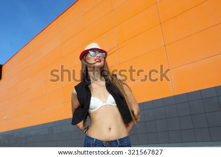 Beautiful laughing girl . Free woman enjoying freedom feeling happy. Hipster girl showing happy positive emotions on the background of the shopping center