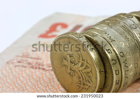 One pound coins on the edge on a white background