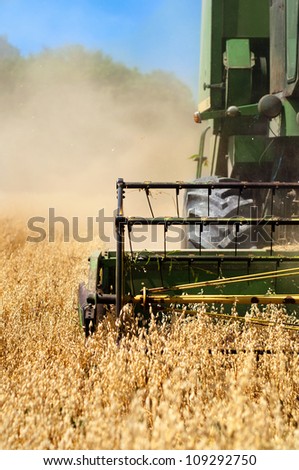 Combine harvesting machinery collecting wheat from the fields